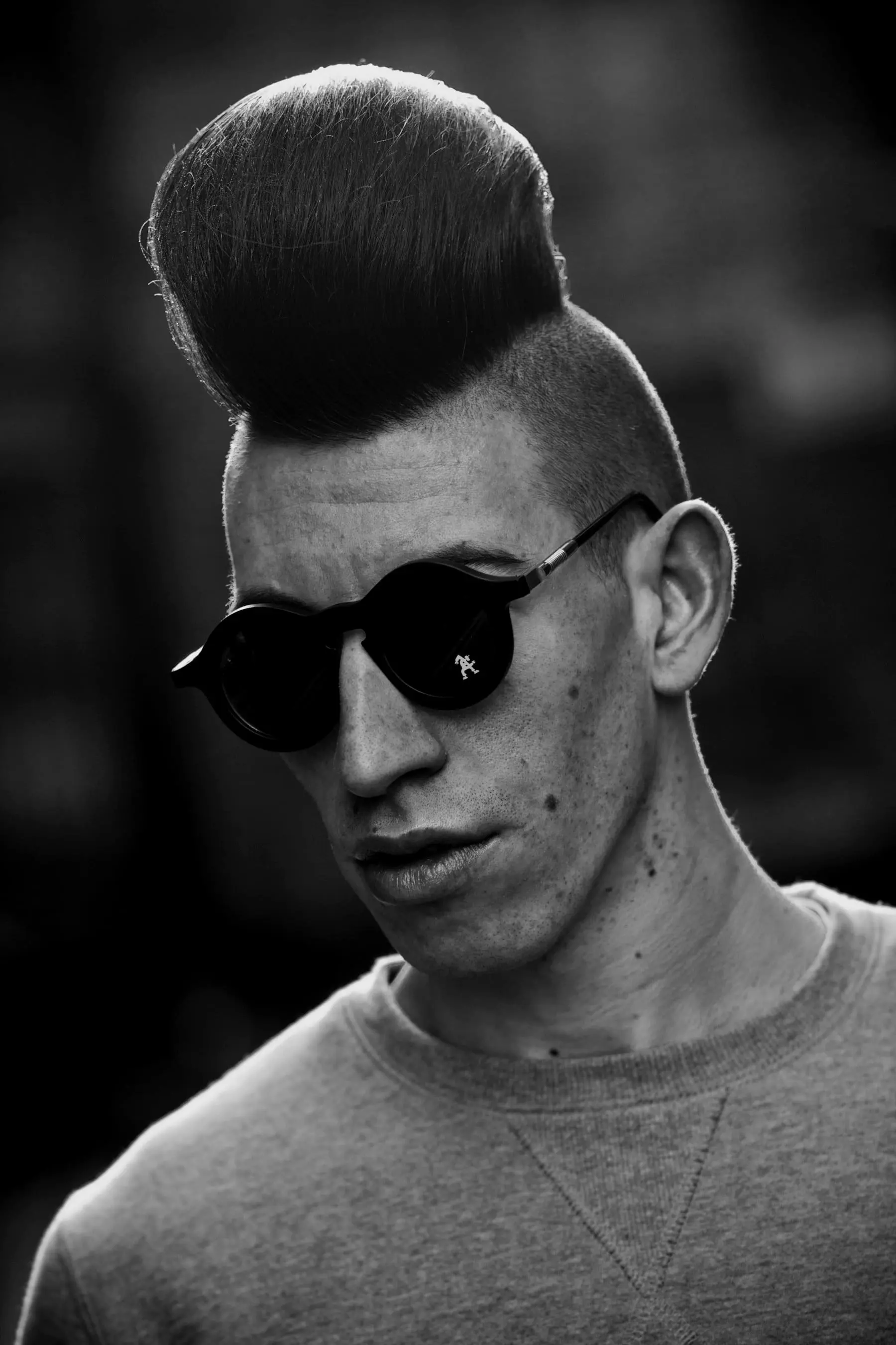 Sam — Portrait of a man in sunglasses with a sculpted quiff and shaved sides