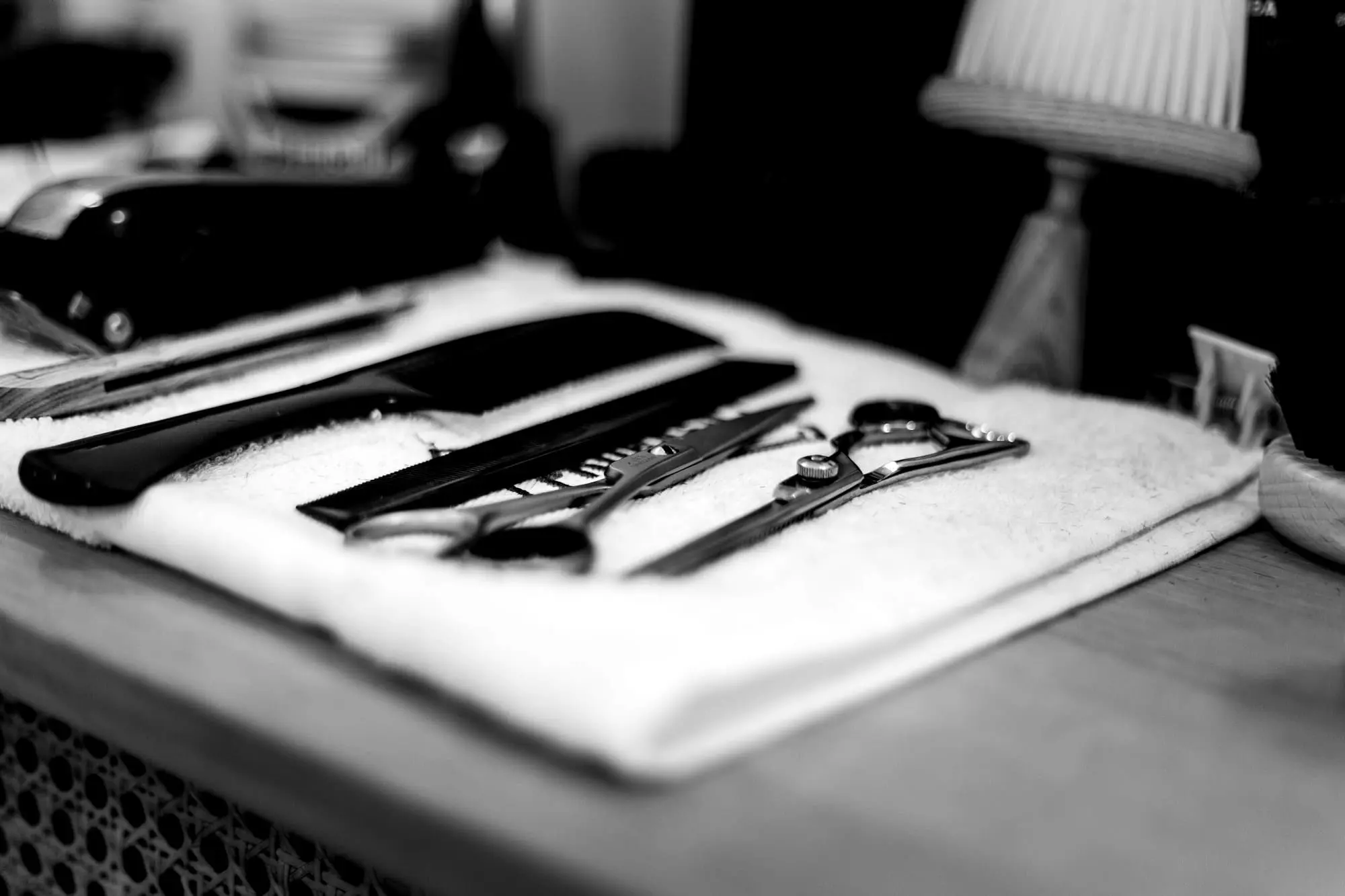Barber's combs and shears laid out on a towel